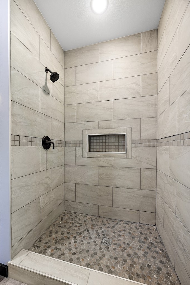 bathroom with tiled shower