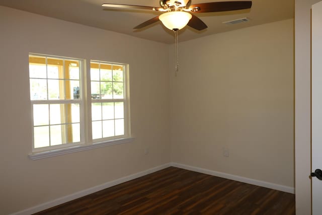 spare room with ceiling fan and dark wood-type flooring