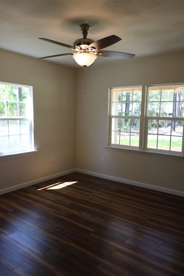 unfurnished room with ceiling fan and dark hardwood / wood-style flooring