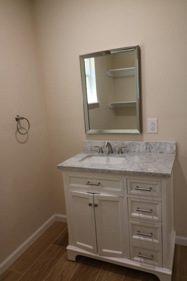 bathroom with hardwood / wood-style floors and vanity