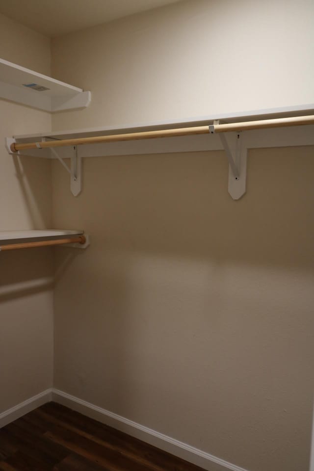 walk in closet featuring dark wood-type flooring