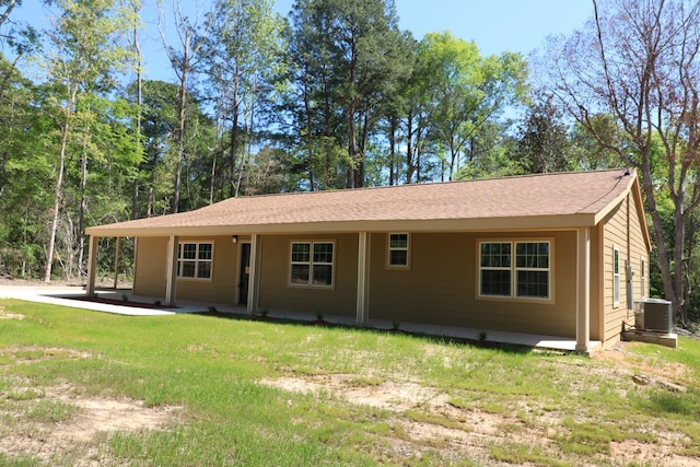 ranch-style home with a porch, central air condition unit, and a front yard