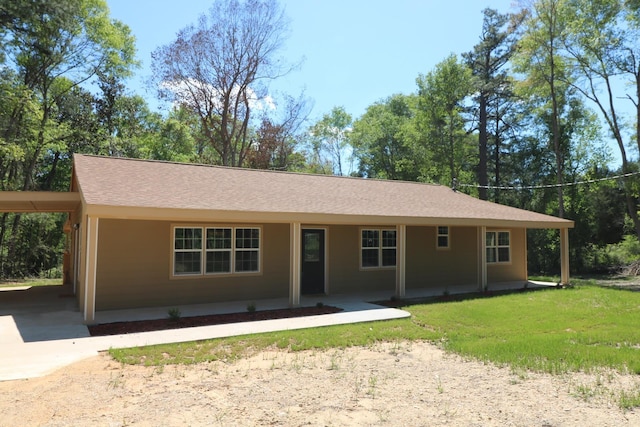 ranch-style house featuring a front yard, a porch, and a carport