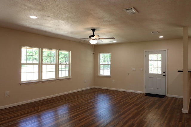 entryway with a textured ceiling, dark hardwood / wood-style flooring, ceiling fan, and a healthy amount of sunlight