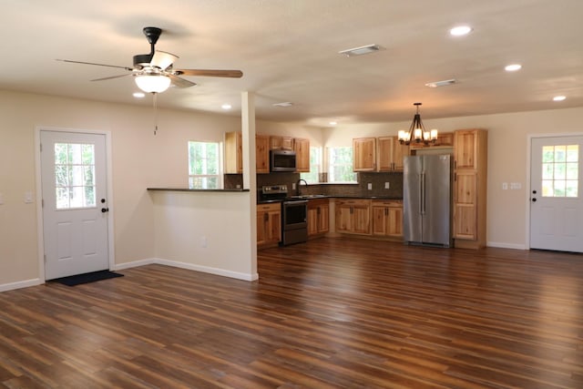 kitchen featuring plenty of natural light, dark wood-type flooring, and appliances with stainless steel finishes