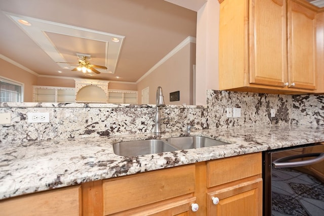 kitchen with light stone counters, ornamental molding, sink, and decorative backsplash