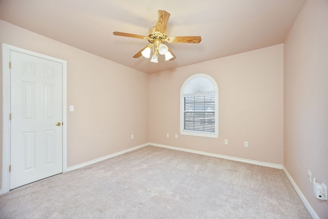 spare room with light colored carpet and ceiling fan