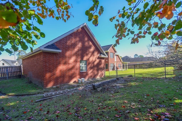 view of side of home with a lawn