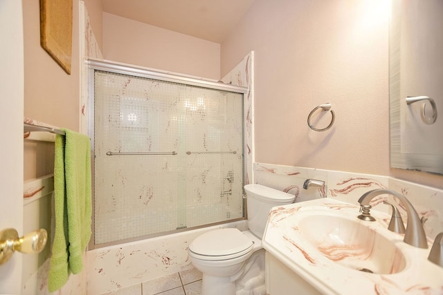 full bathroom with vanity, tile patterned floors, toilet, and combined bath / shower with glass door