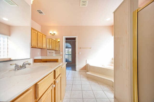 bathroom with vanity, tile patterned flooring, and a washtub