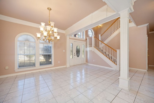 foyer with ornate columns, crown molding, plenty of natural light, and light tile patterned floors