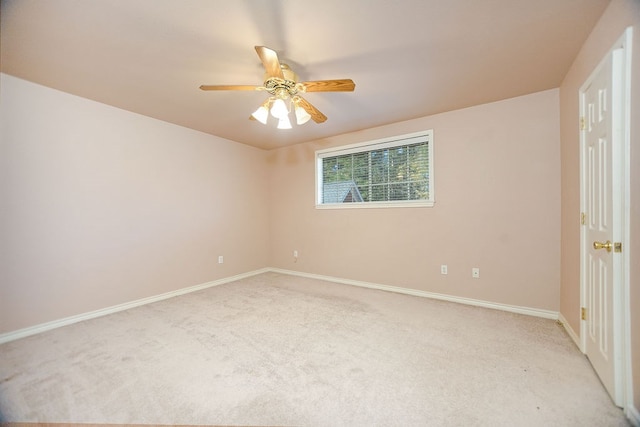 spare room featuring ceiling fan and light colored carpet