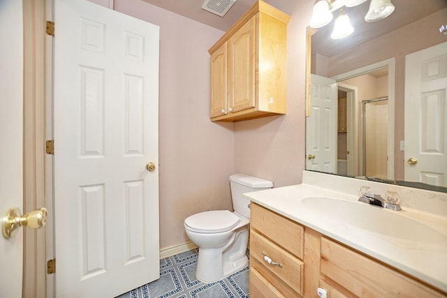 bathroom with vanity, tile patterned flooring, a shower, and toilet