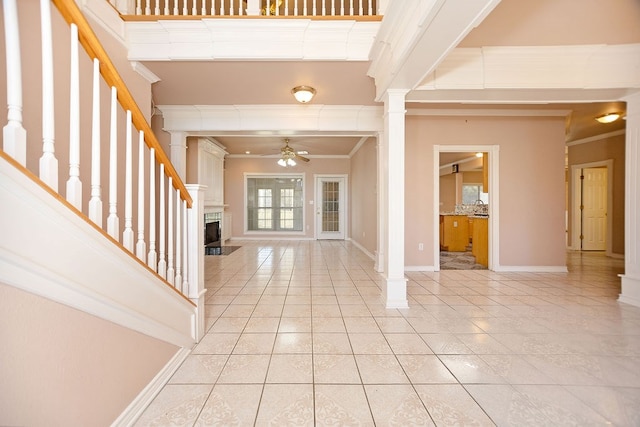 entryway featuring ornamental molding, decorative columns, and ceiling fan