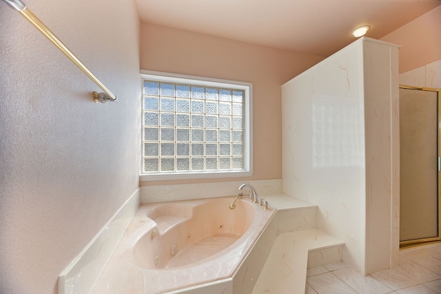 bathroom with tile patterned floors and independent shower and bath