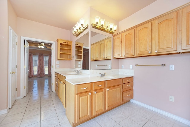 kitchen featuring light tile patterned flooring, sink, and ceiling fan