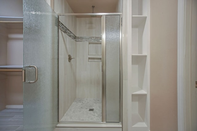 bathroom with a shower with shower door