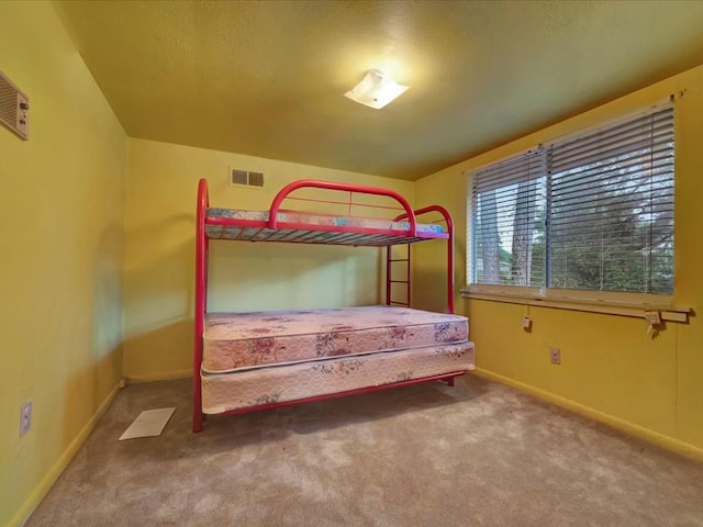 carpeted bedroom featuring a textured ceiling