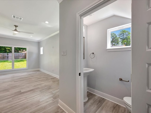 bathroom featuring ceiling fan, toilet, wood-type flooring, and crown molding