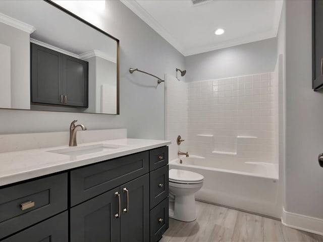 full bathroom featuring hardwood / wood-style floors, vanity, bathing tub / shower combination, toilet, and ornamental molding