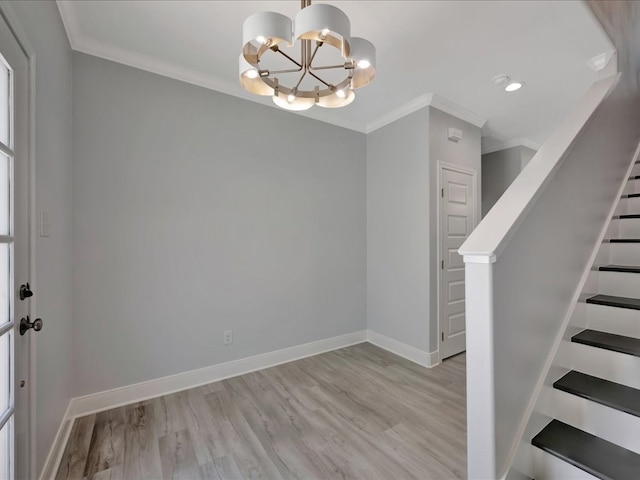 interior space featuring ornamental molding, light hardwood / wood-style floors, and a notable chandelier