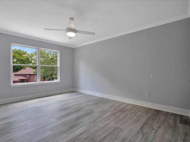 spare room featuring ceiling fan, crown molding, and light hardwood / wood-style flooring