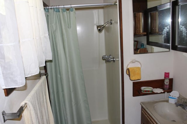 bathroom featuring vanity and a shower with shower curtain