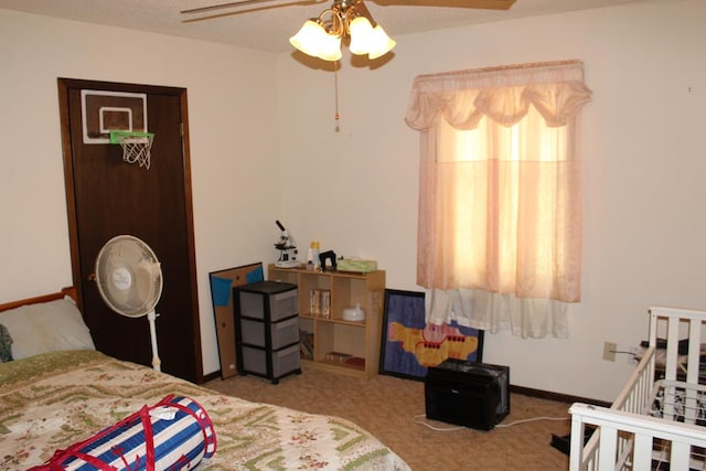 bedroom with ceiling fan and light carpet