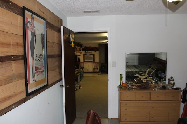 interior space featuring carpet floors and a textured ceiling