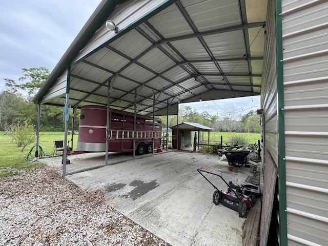 view of parking / parking lot featuring driveway and a detached carport