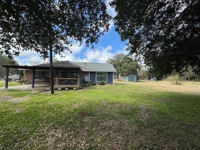 rear view of house featuring a lawn