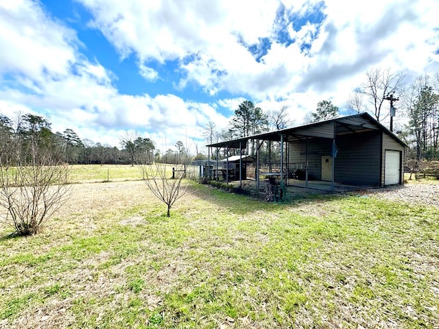 view of yard with a garage and an outdoor structure