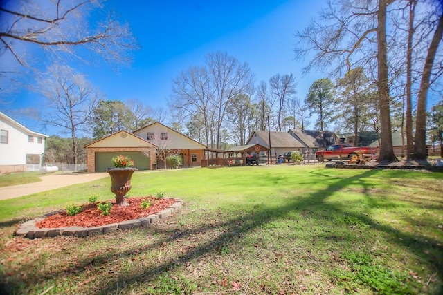 view of yard featuring a garage and driveway