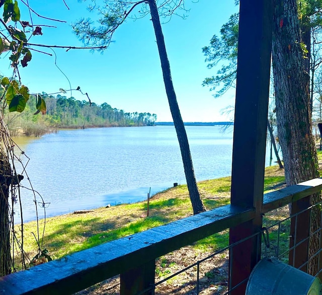property view of water featuring fence