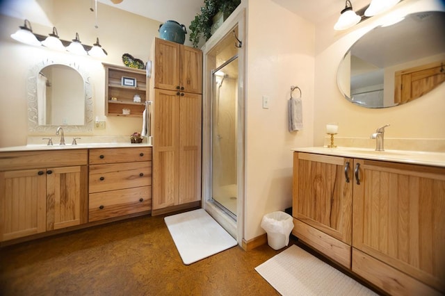 full bath featuring a sink, a stall shower, and two vanities
