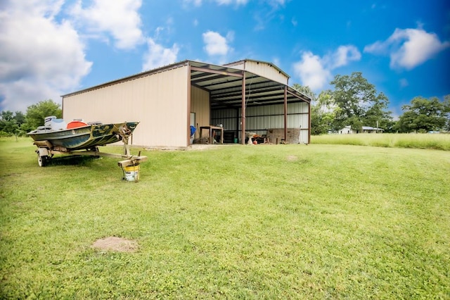 view of pole building featuring a detached carport and a yard