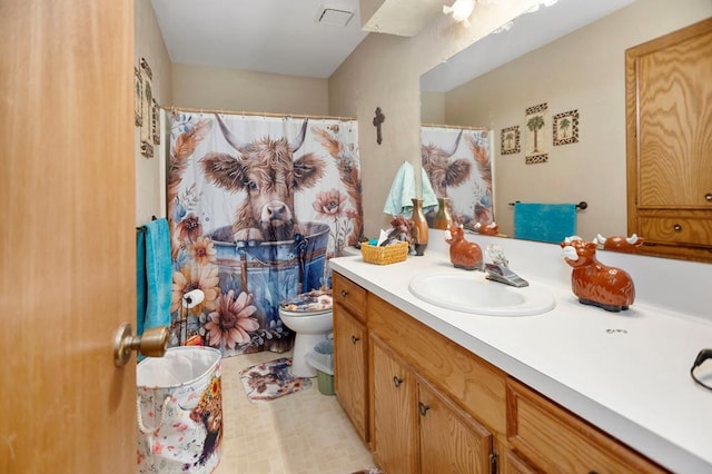 bathroom with vanity, visible vents, and toilet