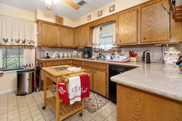 kitchen featuring a sink, dishwasher, a ceiling fan, decorative backsplash, and visible vents