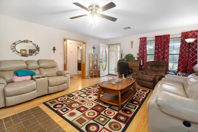living room featuring ceiling fan, wood finished floors, and visible vents