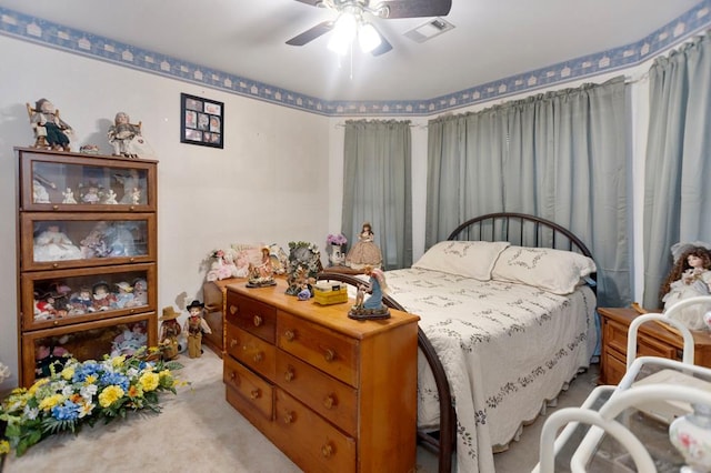 carpeted bedroom featuring a ceiling fan and visible vents