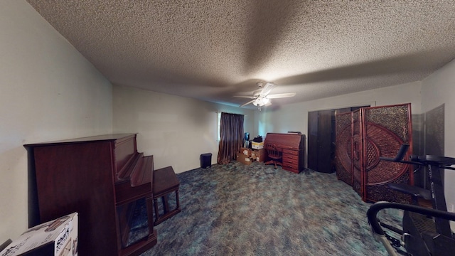 office space with a textured ceiling, ceiling fan, and carpet