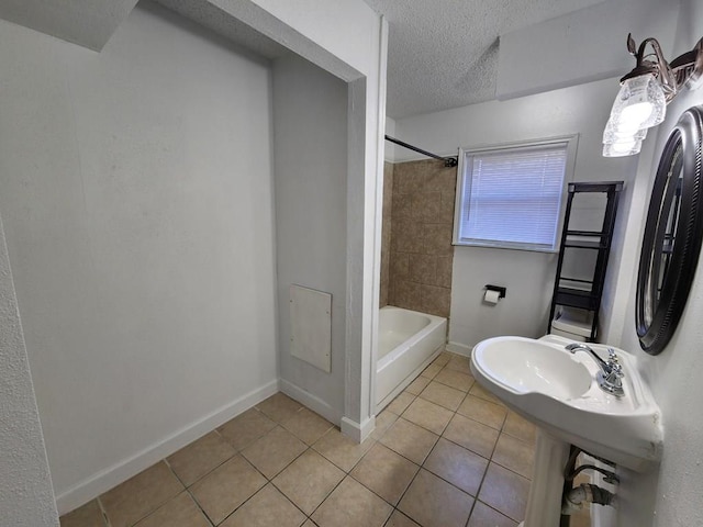 231 Sheila St, Jasper, TX 75951 - full bathroom featuring tile patterned flooring, baseboards, shower / washtub combination, and a textured ceiling