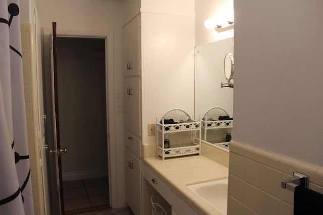 bathroom with tile patterned flooring and vanity