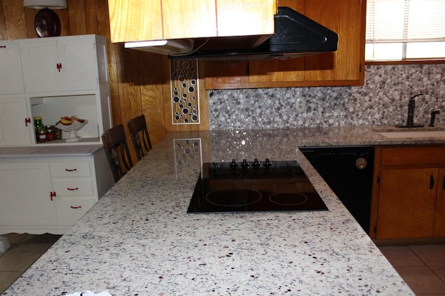 kitchen featuring decorative backsplash, light stone counters, black appliances, sink, and white cabinets