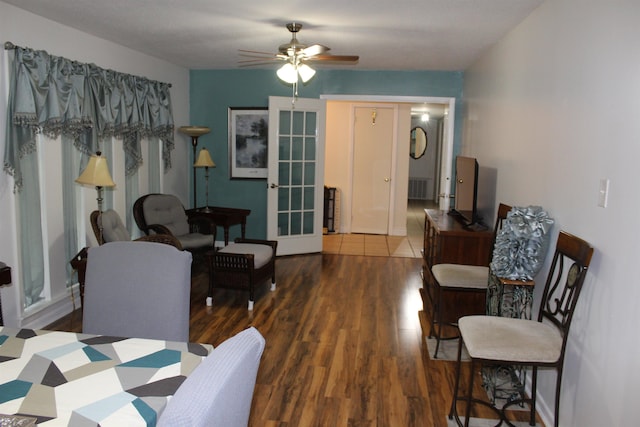 interior space with french doors, ceiling fan, and dark wood-type flooring