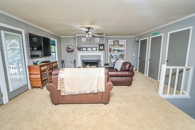 living room with carpet floors, crown molding, and ceiling fan