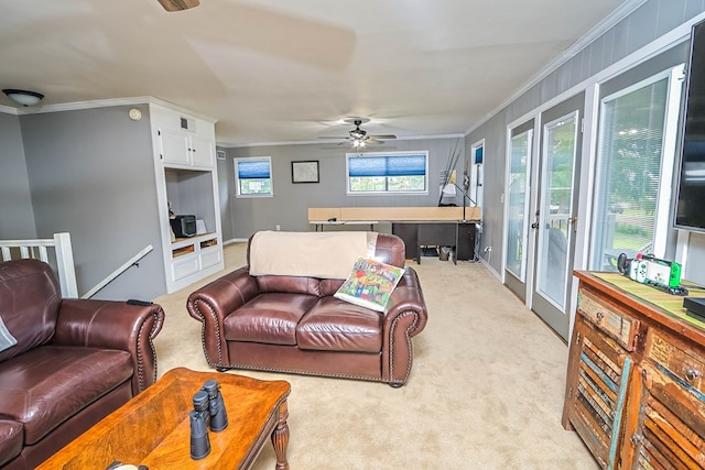 living area featuring crown molding, carpet floors, and a ceiling fan