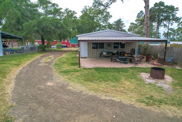 rear view of property with a lawn and fence