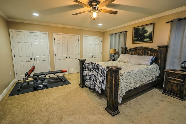 carpeted bedroom featuring baseboards, recessed lighting, a ceiling fan, multiple closets, and ornamental molding