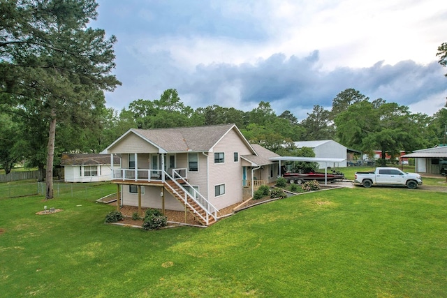 back of property featuring a lawn, fence, a porch, stairs, and a detached carport